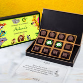 Open box showing unique 1st birthday invitation card chocolates